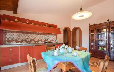 a kitchen with a table with a blue table cloth at Stunning Home In Castellammare Del G in Castellammare del Golfo