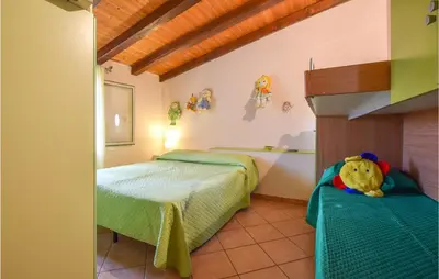 a bedroom with two beds and a teddy bear at Stunning Home In Castellammare Del G in Castellammare del Golfo