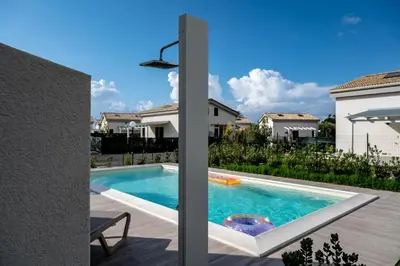 a swimming pool in the backyard of a house at Residence Salinelle Beach Villa Salina 5 in Lascari