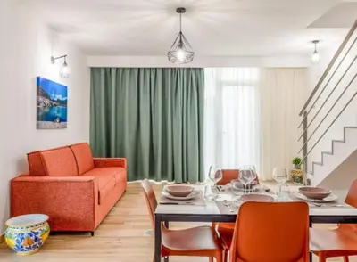 a living room with a table and a couch at Residence Salinelle Beach Villa Salina 5 in Lascari