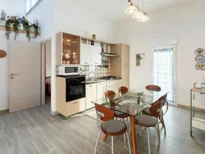 a kitchen with a table and chairs in a room at Apartment in Alcamo near the Beach in Alcamo Marina