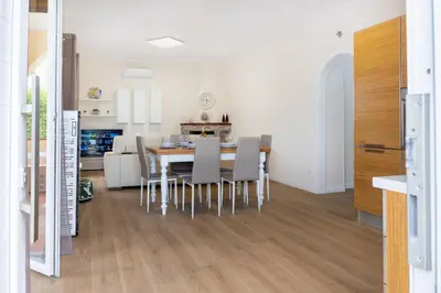 a kitchen and dining room with a table and chairs at Villa Alma in Campofelice di Roccella