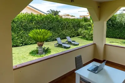 an office with a balcony with a table and chairs at Villa Alma in Campofelice di Roccella