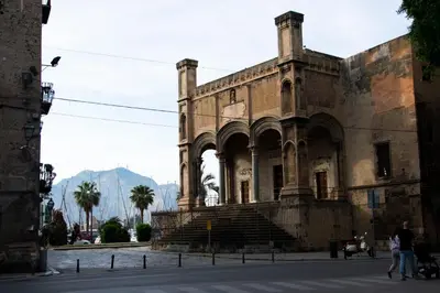 an old stone building with stairs in a street at Abside Suite & Spa in Palermo