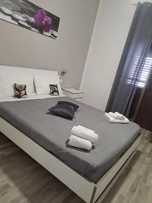 a bedroom with a bed with towels on it at Bedroom la stazione in Palermo