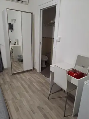 a bathroom with a white desk and a mirror at Bedroom la stazione in Palermo