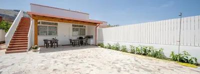 a patio of a house with a table and chairs at Arricàmpati Villa & Bringo Car Rental in Carini