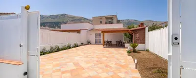 a house with a courtyard with a white fence at Arricàmpati Villa & Bringo Car Rental in Carini
