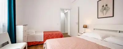 a white bedroom with two beds and a window at Arricàmpati Airport Rooms in Villa & RENT CAR in Carini
