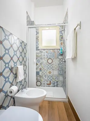 a bathroom with a toilet and a sink and a shower at Arricàmpati Airport Rooms in Villa & RENT CAR in Carini