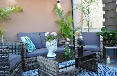 a patio with a couch and a table at Guastella House in Palermo