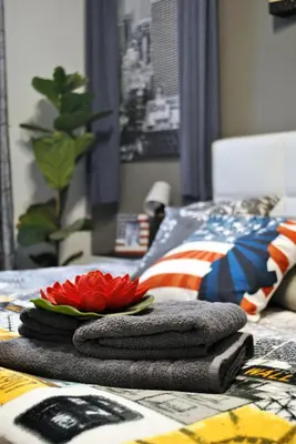 a bed with towels and a plate of flowers on it at Guastella House in Palermo