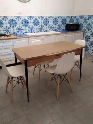 a wooden table in a kitchen with white chairs at Loft - Villa Flore apartments in villa in Casteldaccia