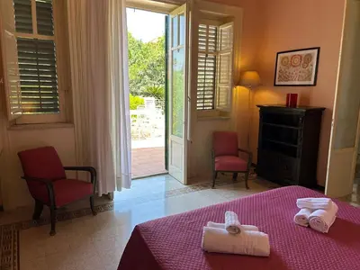 a bedroom with a bed with two towels on it at mondello beach luxury apartments in Palermo