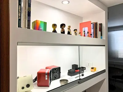 a room with a shelf with books and a sewing machine at home.70 Carini in Palermo