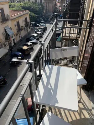 a view of a street with parked cars on a balcony at home.70 Carini in Palermo