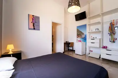 a bedroom with a bed and a desk in it at B&B Kòre in Castellammare del Golfo