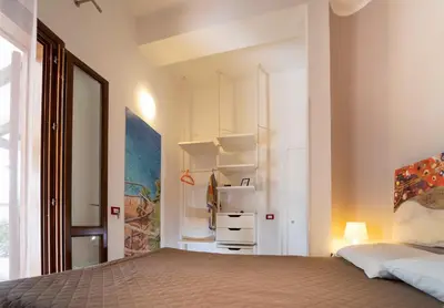 a bedroom with a bed and a closet at B&B Kòre in Castellammare del Golfo