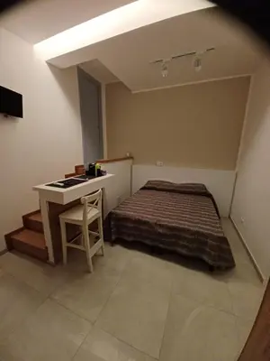 a bedroom with a bed and a desk in it at Sicilia d'Amare in Capaci