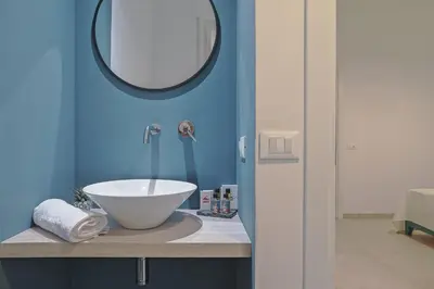 a bathroom with a sink and a mirror at Libertà Central Suites in Palermo