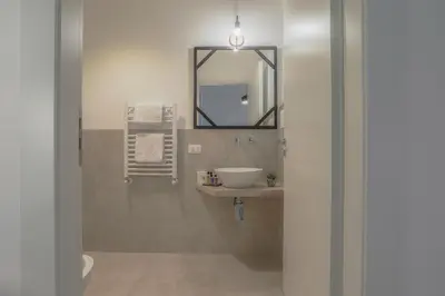 a bathroom with a sink and a mirror at Libertà Central Suites in Palermo