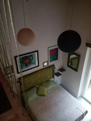 a bedroom with a bed and two pictures on the wall at Arimatea Casa Vacanza in Palermo