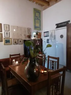 a dining room table with a vase on top of it at Arimatea Casa Vacanza in Palermo