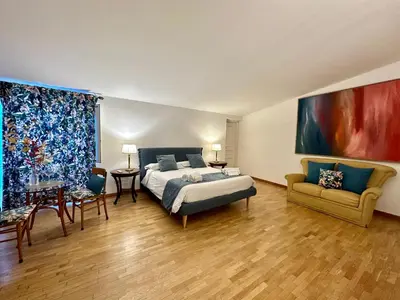 a large bedroom with a bed and a couch at Case Natoli - Residenze d'Epoca in Palermo