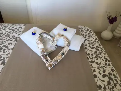 a heart made out of towels on a bed at Sea view life in Carini