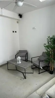 a living room with two beds and a table at Villa DANAE in Mondello
