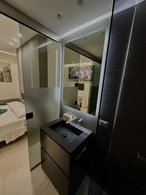 a bathroom with a sink and a mirror at Suites Central Station in Palermo