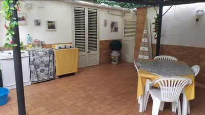 a kitchen with a table and a table and chairs at New Island in Isola delle Femmine