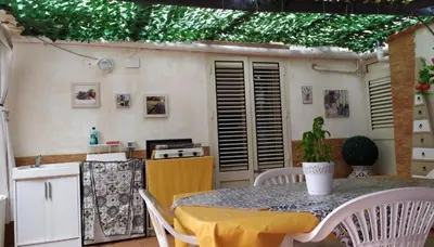 a kitchen with a table and chairs and a kitchen with a counter at New Island in Isola delle Femmine