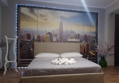 a bedroom with a large mural of a city at New Island in Isola delle Femmine