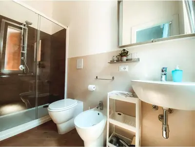 a bathroom with a shower and a toilet and a sink at Lucky Inn, La Locanda della Fortuna in Palermo