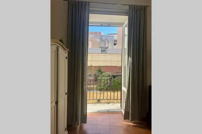 a bathroom with a toilet and a vase of flowers at Piazza Marina Open Space in Palermo