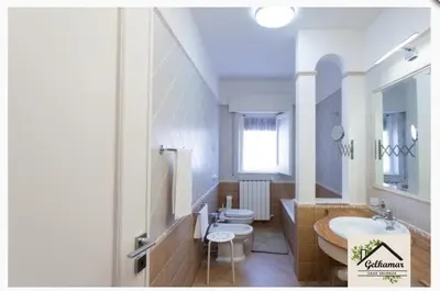 a large bathroom with a sink and a toilet at Gelkamar Apartment in Santa Flavia