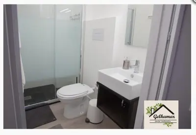 a bathroom with a toilet and a sink and a shower at Gelkamar Apartment in Santa Flavia