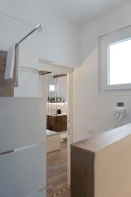 a bedroom with a bed and a table with a stool at Carrettieri54 - apartment historic center Palermo in Palermo