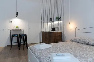 a bedroom with a bed with two towels on it at Carrettieri54 - apartment historic center Palermo in Palermo