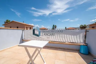 a white chair on a balcony with a fence at Villa Pietro in Lascari