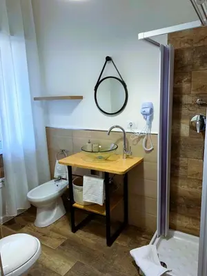 a bathroom with a sink and a toilet and a shower at Civico 20 in Palermo