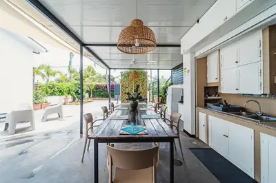 a kitchen and dining room with a long table and chairs at Airport sicily home palermo in Carini