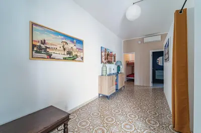 a hallway with a painting hanging on a wall at Airport sicily home palermo in Carini