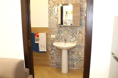 a bathroom with a sink and a mirror at Ciuri di Sicilia in Capaci