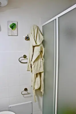 a towel hanging on a shower door in a bathroom at Nido Verde Locazione turistica Palermo in Palermo