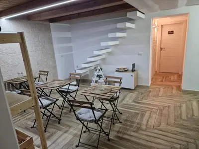 a room with tables and chairs and a staircase at Calypso Il Binario Elegance in Palermo