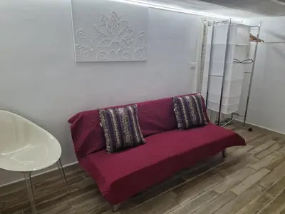 a red couch with two pillows in a room at Calypso Il Binario Elegance in Palermo