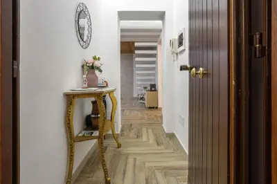 a hallway with a table and a mirror on a wall at Calypso Il Binario Elegance in Palermo
