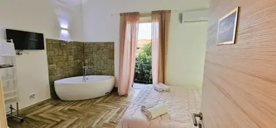 a bathroom with a bath tub and a window at Calypso Il Binario Elegance in Palermo